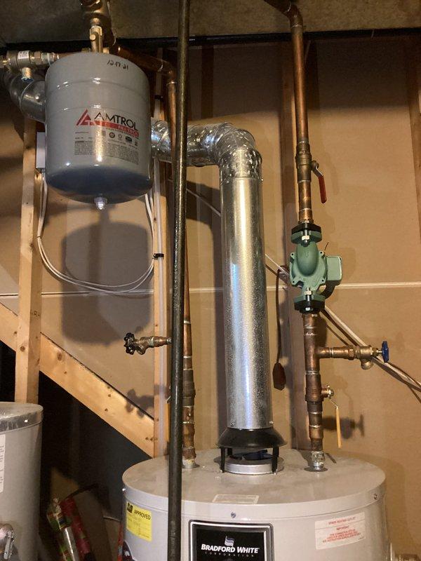 Responded to reported bathroom faucet issue requiring evaluation. Upon arrival, conducted thorough inspection of plumbing systems including water heater installation, expansion tank, and associated copper piping connections in basement utility area. Documented existing mechanical equipment configuration with Bradford White water heater system, Amtrol expansion tank, shut-off valves, and pressure relief components for maintenance records.