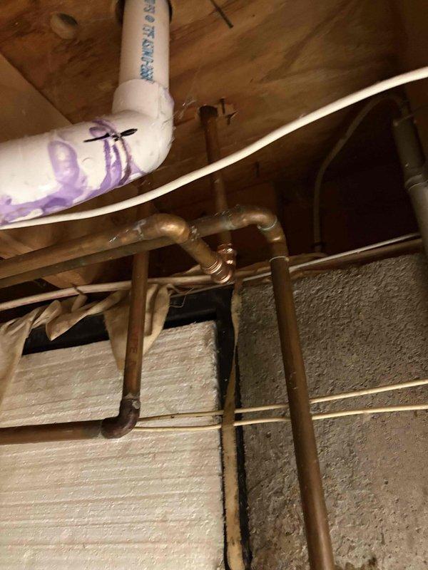 Installed new shutoff valve on copper water supply line in basement to provide dedicated water source for refrigerator icemaker. Accessed existing cold water distribution piping beneath first floor joists, cut into copper line, and installed compression-style shutoff valve with quarter-inch outlet for icemaker connection. Routed flexible water supply line from new valve location through floor structure to refrigerator location in adjacent laundry/utility area, securing line to floor joists with appropriate strapping to prevent sagging or damage. Tested valve operation and checked for leaks at all connection points to ensure proper installation and water flow to appliance.