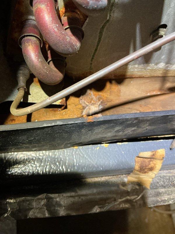 # Condensate Drain Issue Resolution

Responded to complaint of condensate dripping and water damage concerns. Upon inspection, discovered excessive moisture accumulation on copper refrigerant lines and significant frost buildup on suction line insulation, indicating potential airflow restriction or refrigerant charge issues. Examined condensate drainage system including primary drain line routing and humidifier installation. Verified proper drain pan condition and drainage pathways. Documented equipment conditions including Aprilaire humidifier integration with ductwork system and associated plumbing connections. Provided assessment findings and recommendations for resolving water intrusion issues.
