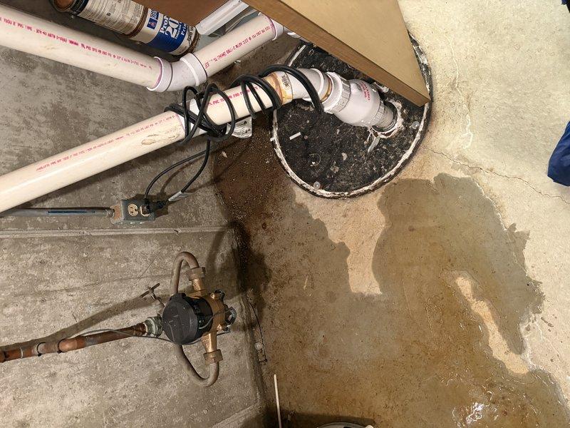 Responded to service call for furnace leaking water while still operational. Upon inspection, discovered water accumulation on concrete floor beneath HVAC system with visible moisture damage and staining around plumbing components. Investigated ductwork interior and identified yellow-tan discoloration along seam joints indicating moisture exposure. Examined PEX piping, valve assemblies, and drain connections in utility area. Documented evidence of active water leak affecting furnace operation and surrounding floor area. Photographed affected components including duct seams, floor water damage, and plumbing infrastructure for service records.