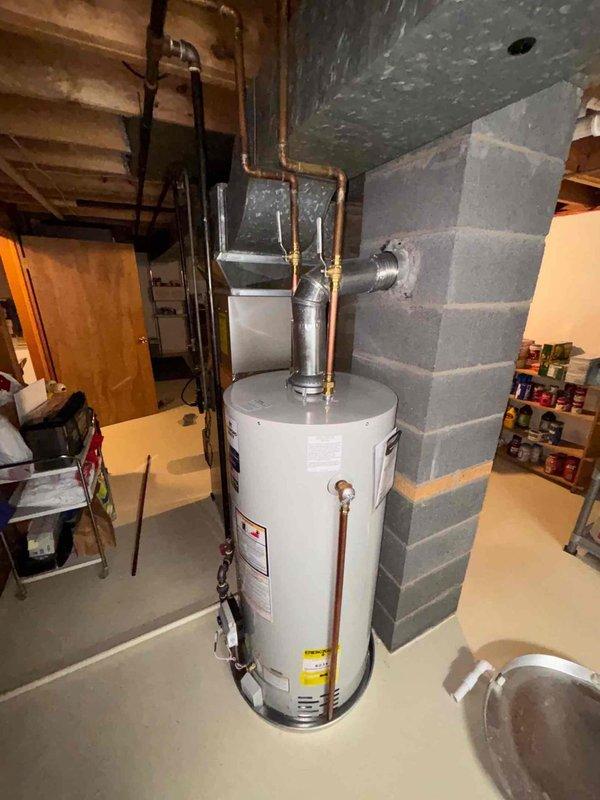 Responded to service call for noise coming from residential water heater. Upon arrival, inspected 8-year-old unit and confirmed water heater was still producing hot water and functioning properly. Performed visual inspection of tank, connections, and all plumbing components. Checked temperature and pressure relief valve, copper supply lines, and flue venting system for proper operation. Documented current condition of unit with photos showing standard residential installation with proper venting and safety components in place. Unit continues to heat water effectively despite noise complaint.