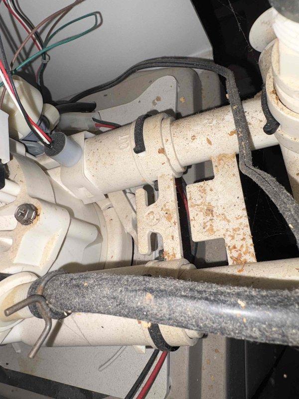 Performed water conditioning system evaluation and provided estimate for water softener installation. Inspected existing plumbing connections, mechanical components, and installation area to assess requirements for new equipment. Documented current system condition showing mineral deposits, rust staining, and discoloration on existing components indicating hard water issues. Evaluated electrical connections, drain provisions, and space availability for proper water softener placement and integration with existing plumbing infrastructure.