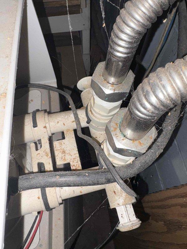 Performed water conditioning system evaluation and provided estimate for water softener installation. Inspected existing plumbing connections, mechanical components, and installation area to assess requirements for new equipment. Documented current system condition showing mineral deposits, rust staining, and discoloration on existing components indicating hard water issues. Evaluated electrical connections, drain provisions, and space availability for proper water softener placement and integration with existing plumbing infrastructure.