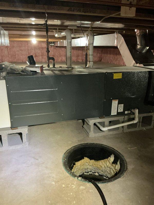 Completed annual cooling maintenance on a 7-year-old air conditioning system with horizontal air handler located in basement crawl space. Performed comprehensive system inspection, verified proper operation of all components, checked refrigerant levels, cleaned condensate drain system, and documented equipment condition with photos showing air handler unit and associated ductwork in good working order.