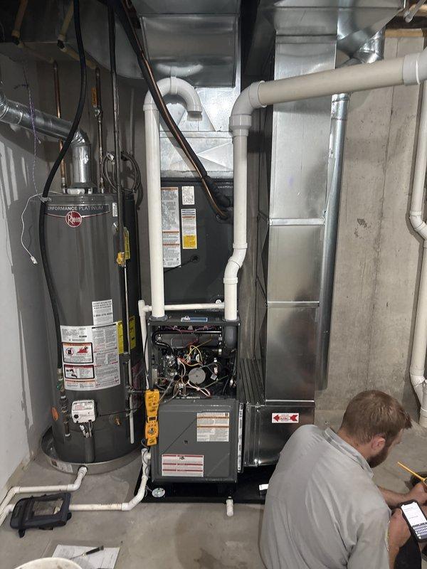 Completed full HVAC system installation including new furnace and air conditioning unit. Installed Amana outdoor condenser on concrete pad with proper clearances, connected refrigerant lines and electrical conduit to exterior wall. Interior installation included new furnace with blower assembly in basement mechanical room, integrated with existing ductwork and ventilation systems. Verified all electrical connections, tested system operation, and confirmed proper airflow throughout. System commissioned and left in full operational status.