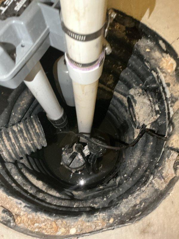 Responded to complaint of sump pump running constantly with excessive noise audible throughout home. Upon inspection, found pump cycling continuously despite low water level in basin, indicating faulty float switch. Customer had unplugged unit to prevent damage from dry running. Tested pump operation, confirmed float mechanism failure causing pump to activate regardless of water level. Documented existing installation showing submersible pump in basin with standing water and sediment accumulation. Recommended float switch replacement or full pump replacement to restore proper automatic operation and eliminate noise issue.