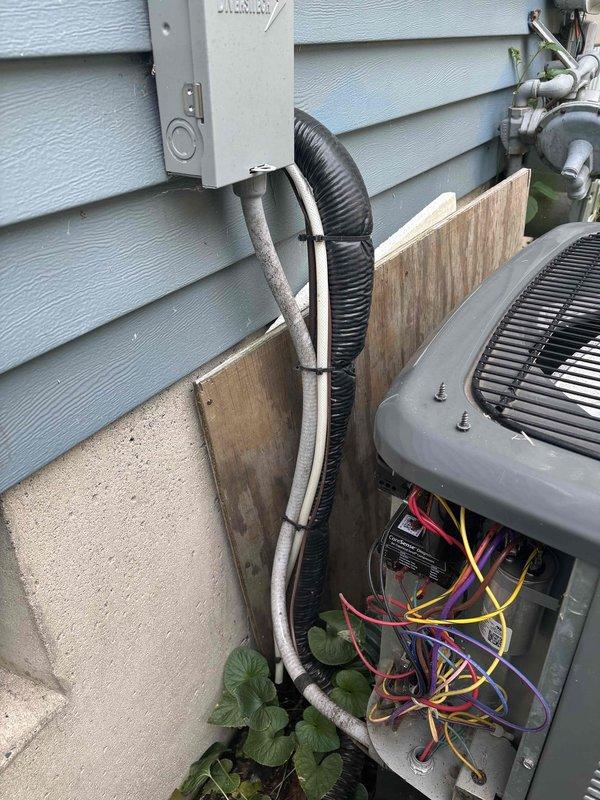 Completed annual cooling maintenance on EnergiAir air conditioning system. Performed comprehensive tune-up including inspection of outdoor condenser unit, electrical connections, and refrigerant lines. Verified proper operation of disconnect box, examined wiring connections within unit access panel, and confirmed secure mounting of all components including conduit and refrigerant lines along exterior wall. System operating within normal parameters upon completion of preventive maintenance service.