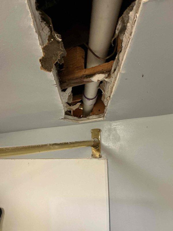 Replaced failed kitchen drain line that was leaking within the ceiling cavity. Accessed the damaged piping by opening the ceiling, removed the deteriorated section, and installed new PVC drainage pipe with proper slope and connections. Restored water-tight drainage system; drywall repair required by separate trade.