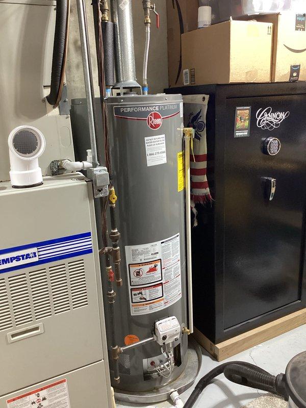 Responded to service call for one-year-old Rheem Performance Platinum water heater experiencing leak from bottom of unit. Conducted on-site assessment, documented equipment condition through photography, and identified source of leak requiring water heater replacement estimate due to tank failure.