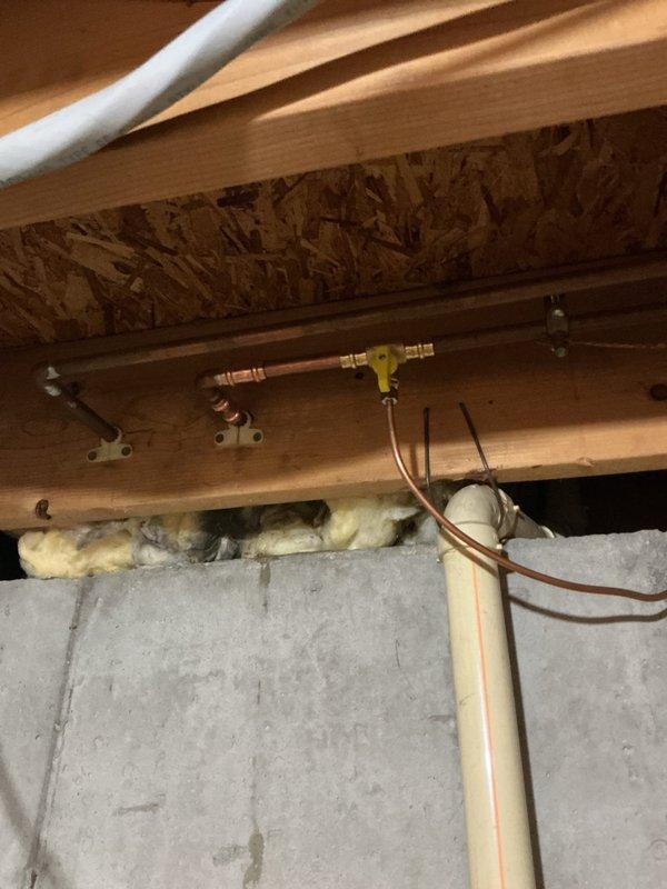 Installed new copper water supply line for refrigerator, routing from existing plumbing system through attic space to kitchen location. Connected line using brass compression fittings and secured piping to structural members with appropriate mounting brackets, ensuring proper support and code compliance throughout the installation.