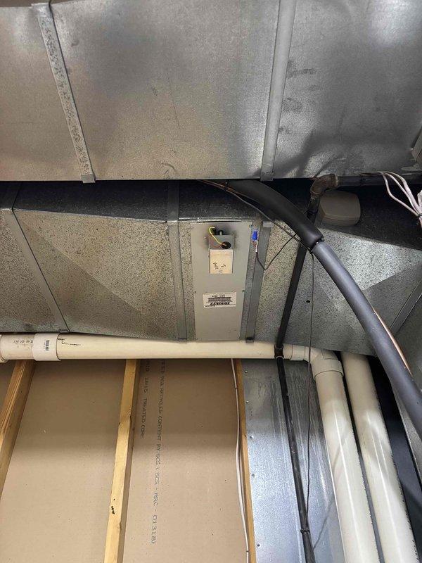 Responded to noise complaint on 9-year-old EnergiAir system installed in garage. Upon inspection, verified unit was cooling properly but operating louder than normal. Examined indoor air handler, ductwork connections, and zone control wiring for potential sources of vibration or mechanical noise. Documented existing system configuration including thermostat zone control board and ductwork installation with photos for reference. Customer advised of findings and system continues to operate with adequate cooling performance.