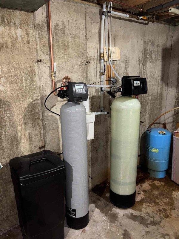 Completed comprehensive plumbing project including installation of three new exterior spigots with dedicated 1" supply line to rear garden area configured for proper winterization protocols. Upsized existing home run piping to 1" diameter to maintain adequate pressure throughout the system. Installed 2 cubic foot iron filtration system to treat water containing 5 mg/L iron concentration for all interior and exterior fixtures. Installed 1.5 cubic foot water softener unit with digital control head to address 20 grains per gallon hardness level. All equipment mounted in basement utility area with copper supply lines, brass fittings, and appropriate shut-off valves. System tested and operational upon completion.