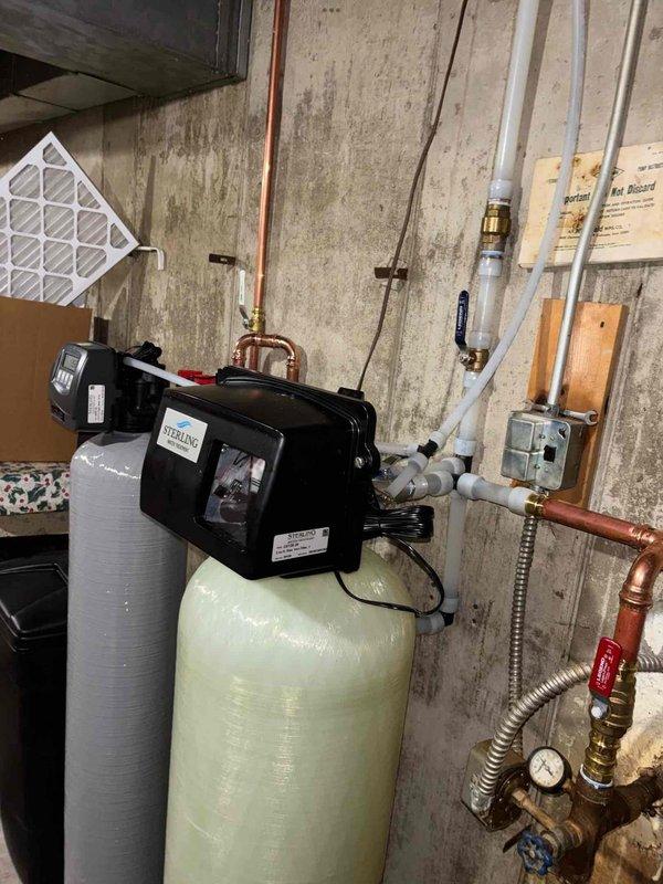 Completed comprehensive plumbing project including installation of three new exterior spigots with dedicated 1" supply line to rear garden area configured for proper winterization protocols. Upsized existing home run piping to 1" diameter to maintain adequate pressure throughout the system. Installed 2 cubic foot iron filtration system to treat water containing 5 mg/L iron concentration for all interior and exterior fixtures. Installed 1.5 cubic foot water softener unit with digital control head to address 20 grains per gallon hardness level. All equipment mounted in basement utility area with copper supply lines, brass fittings, and appropriate shut-off valves. System tested and operational upon completion.