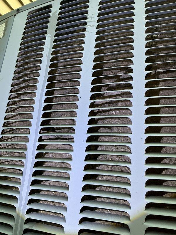 # AC Annual Cooling Maintenance - 14-Year-Old EnergiAir System

Completed comprehensive annual cooling maintenance on a 14-year-old EnergiAir air conditioning system with condenser manufactured in 2017. Performed standard tune-up procedures to ensure optimal system performance for the cooling season.

## Work Performed

Conducted thorough system inspection and preventive maintenance services. Replaced dirty air filter with new pleated filter to restore proper airflow and system efficiency. Previous filter showed significant dust and debris accumulation, which was restricting airflow through the system.

Inspected outdoor condenser unit and noted heavy accumulation of dirt, dust, and debris on exterior louvered panels and internal components. The four-column ventilation grille showed substantial buildup of dark material throughout the slat openings, indicating extended period since last cleaning. This accumulation can reduce heat transfer efficiency and system performance.

Documented s