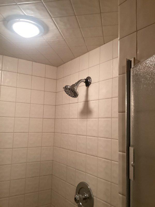 Replaced corroded showerhead, shower arm, and flange in bathroom shower stall. All new fixtures installed with chrome finish to match existing faucet trim, ensuring proper water flow and eliminating corrosion issues.