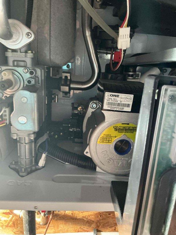 Responded to service call for ongoing water heater issues with 8-year-old Navien tankless unit. Inspected wall-mounted system including heat exchanger assembly, circulation pump, gas valve, and digital control panel. Documented internal mechanical components and operational status of unit with photos showing all major connections, plumbing interfaces, and electrical wiring in proper working condition.