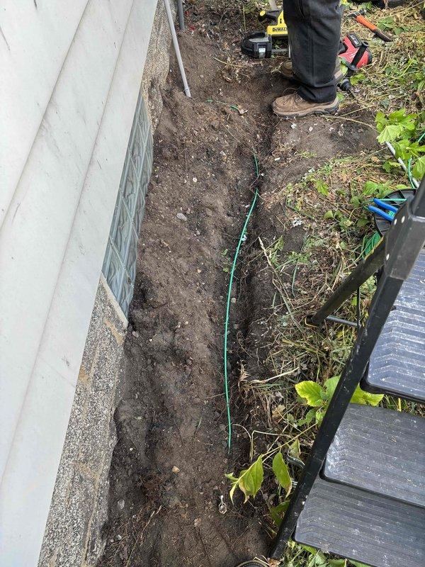 Completed 100-amp electrical service upgrade with meter relocation on residential property. Coordinated utility disconnect and reconnect, obtained electrical permit BR-ELEC-2026-1055, and installed new galvanized metal conduit along exterior wall from foundation to roofline with proper mounting brackets. Excavated trench along building foundation to route underground service conductors, relocated meter base, and scheduled required electrical inspection.