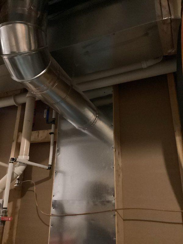 Responded to water heater emergency where utility company had shut off gas supply due to safety concerns regarding carbon monoxide venting and small leak detection. Upon arrival, inspected 9-year-old residential water heater that had been red-tagged by utility for improper venting conditions. Conducted thorough assessment of venting system, examining flue pipe connections, draft hood, and exhaust pathway for proper combustion air flow and carbon monoxide discharge. Identified compromised venting components and minor leak at tank connections. Documented existing conditions with photographs showing water heater installation, surrounding mechanical equipment, and HVAC ductwork configuration in basement mechanical room. Verified no active gas odor present and confirmed CO alarms were not activated at time of inspection. Evaluated unit's operational history noting decreased efficiency prior to shutdown. Provided homeowner with assessment findings and recommended corrective actions required 