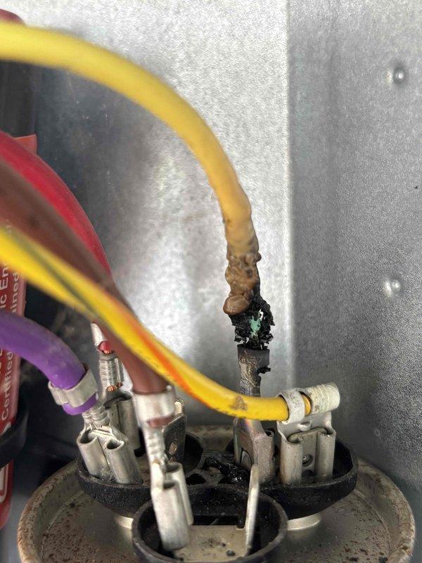 Completed annual cooling maintenance on 2018 EnergiAir system under 2-year warranty agreement. Upon inspection, discovered significant electrical arcing and heat damage on capacitor terminal connection with visible burn marks, corrosion, and thermal discoloration. Replaced failed dual-run capacitor and damaged wire terminals to prevent system failure and potential safety hazard. Tested all electrical connections, verified proper voltage and amperage readings, and confirmed system operation within manufacturer specifications.