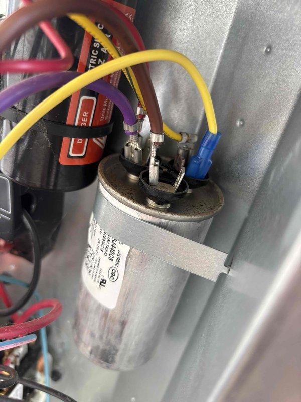 Completed annual cooling maintenance on 2018 EnergiAir system under 2-year warranty agreement. Upon inspection, discovered significant electrical arcing and heat damage on capacitor terminal connection with visible burn marks, corrosion, and thermal discoloration. Replaced failed dual-run capacitor and damaged wire terminals to prevent system failure and potential safety hazard. Tested all electrical connections, verified proper voltage and amperage readings, and confirmed system operation within manufacturer specifications.