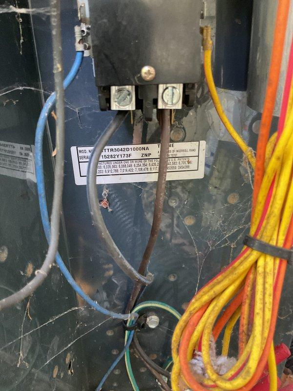 Completed annual cooling maintenance on 10-year-old Trane system. Performed comprehensive AC tune-up including inspection of electrical connections, condensate drain assembly, and internal components. Noted presence of pets at property and exercised appropriate caution during service. Inspected and documented condition of condensate pump mechanism with PVC drain piping, verified proper operation of drain system. Examined electrical panel wiring connections, terminal blocks, and color-coded wire routing including blue, brown, yellow, orange, and green ground wires. All electrical connections found secure at terminals. System operational and ready for cooling season.