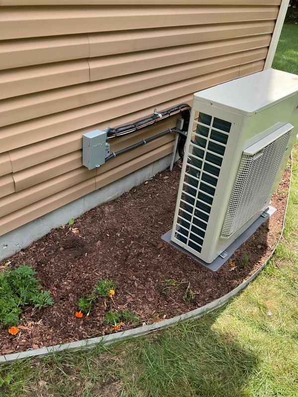 Completed full residential HVAC system installation including new furnace and air conditioning condenser unit. Installed furnace in basement mechanical room with metallic ductwork plenum and proper duct connections, positioned outdoor condensing unit on mulch bed with appropriate refrigerant line routing through building exterior secured with wall-mounted brackets. All equipment installed per manufacturer specifications with proper drainage considerations and system startup completed successfully.