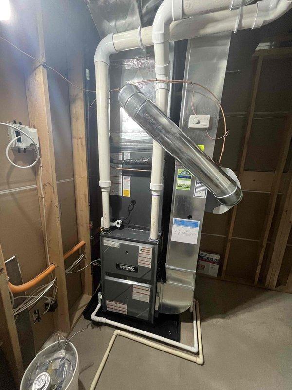 Completed full HVAC system installation including new furnace unit in basement utility area and outdoor condensing unit. Installed all necessary ductwork, PVC venting, refrigerant line sets, and electrical connections per manufacturer specifications. Both units tested and operational, with all components properly secured and integrated into existing home infrastructure.