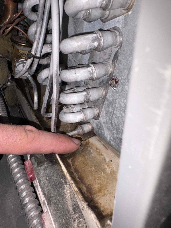 Responded to water leak call involving furnace condensate drainage issue. Upon inspection, identified water accumulation originating from the HVAC condenser system. Examined evaporator coil assembly and associated condensate drain lines in the mechanical room. Inspected PVC drainage piping, copper refrigerant lines, and shut-off valves for proper operation and potential leak sources. Verified heating system operational status and documented plumbing connections including water supply lines and drainage components. Photographed evaporator coil configuration and mechanical room piping arrangement for service records. System restored to proper operation with condensate drainage functioning correctly.