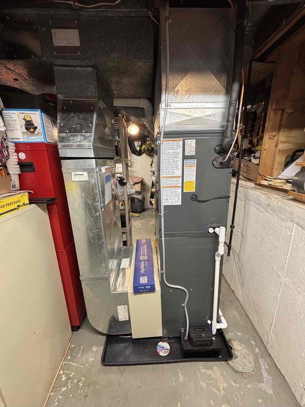 Completed full HVAC system replacement including installation of new furnace with air handler, air conditioning unit, and water heater in basement mechanical room. All equipment installed to manufacturer specifications with proper venting, ductwork connections, electrical hookups, and plumbing configurations. System tested and verified operational with financing paperwork processed for same-day completion.