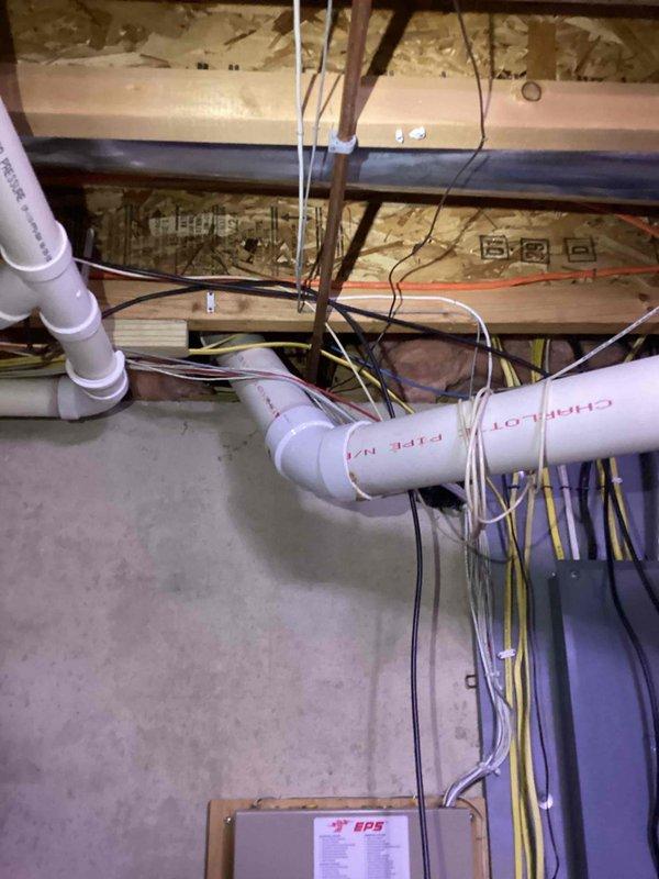 Responded to call for leaking 15-year-old tank water heater in basement with water observed leaking from bottom of unit. Upon inspection, confirmed active leak from base of tank indicating internal tank failure, consistent with age and expected service life of residential water heater installed in 2011. Documented existing installation including plumbing connections, electrical wiring, condensate pump assembly, and PVC venting configuration. Provided estimate for complete water heater replacement including removal and disposal of failed unit, installation of new tank water heater with appropriate venting, and reconnection of all water supply lines and electrical components to restore domestic hot water service.