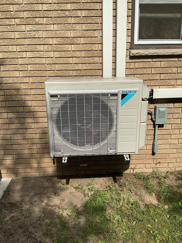 Responded to report of water leak and malfunctioning mini-split system with two bedroom units shutting off prematurely after short runtime. Inspected 9-year-old Daikin mini-split system including outdoor condenser unit and indoor wall-mounted air handlers. Documented exterior condenser unit condition and interior components including condensate drainage system and refrigerant lines. System requires further diagnosis to determine cause of intermittent shutdown and water leakage issue.