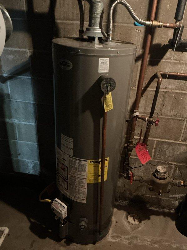 Completed annual cooling maintenance on EnergiAir system model WT 03-2034. Performed standard tune-up procedures including inspection of refrigerant levels, electrical connections, and operational components. Documentation photos captured basement utility area showing water heater, plumbing connections, sump pump system, and water softener equipment for service records.