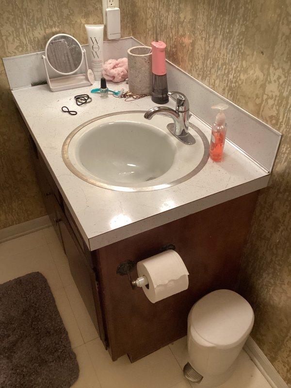 Conducted on-site assessment for tub-shower replacement estimate in residential bathroom. Documented existing alcove-style white bathtub with standard chrome fixtures including wall-mounted shower valve, tub spout, and vertical supply pipe, along with white subway tile surround. Photographed current bathroom configuration including vanity area to provide comprehensive quote for new tub-shower installation.