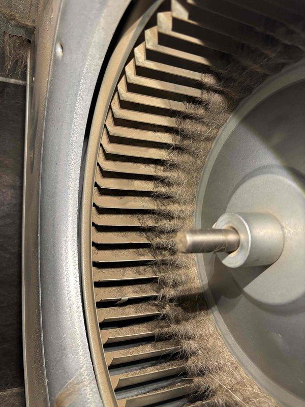 Responded to no cooling complaint on recently installed Carrier unit unable to maintain setpoint temperature. Upon inspection, discovered severely restricted blower wheel with heavy accumulation of dust, lint, and fibrous debris throughout assembly. Removed and thoroughly cleaned blower wheel and housing to restore proper airflow. System tested and confirmed adequate cooling performance with proper temperature differential. Unit now cycling normally and maintaining desired setpoint.