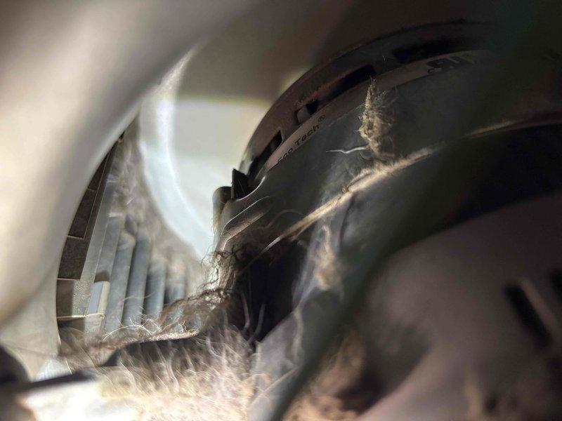 Responded to no cooling complaint on recently installed Carrier unit unable to maintain setpoint temperature. Upon inspection, discovered severely restricted blower wheel with heavy accumulation of dust, lint, and fibrous debris throughout assembly. Removed and thoroughly cleaned blower wheel and housing to restore proper airflow. System tested and confirmed adequate cooling performance with proper temperature differential. Unit now cycling normally and maintaining desired setpoint.