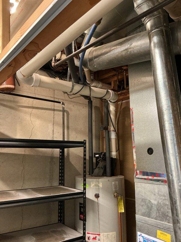 Conducted comprehensive water heater replacement estimate for residential property, evaluating both tankless and traditional tank-style options. Assessed existing installation in basement utility area, documenting current water heater configuration, surrounding HVAC ductwork, plumbing infrastructure including PVC and copper supply lines, and available clearances for equipment replacement. Provided customer with detailed comparison of tankless versus tank water heater solutions to support informed purchasing decision.
