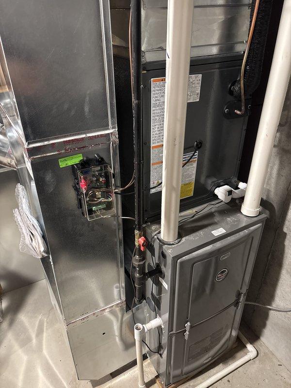 Completed full residential air conditioning system replacement including outdoor condensing unit and indoor air handler. Installed new outdoor unit on existing concrete pad with proper electrical disconnect and refrigerant line connections. Mounted new indoor air handler in basement utility area with integrated ductwork connections, PVC condensate drainage, and electrical wiring. All components tested and verified operational upon completion.