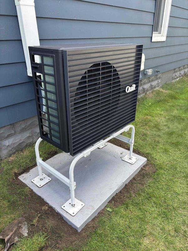 Installed protective plastic pad underneath existing mini split heat pump stand to prevent damage to concrete mounting surface. Verified unit remained level after pad installation and confirmed stable mounting configuration. No-charge service completed as preventative maintenance measure.