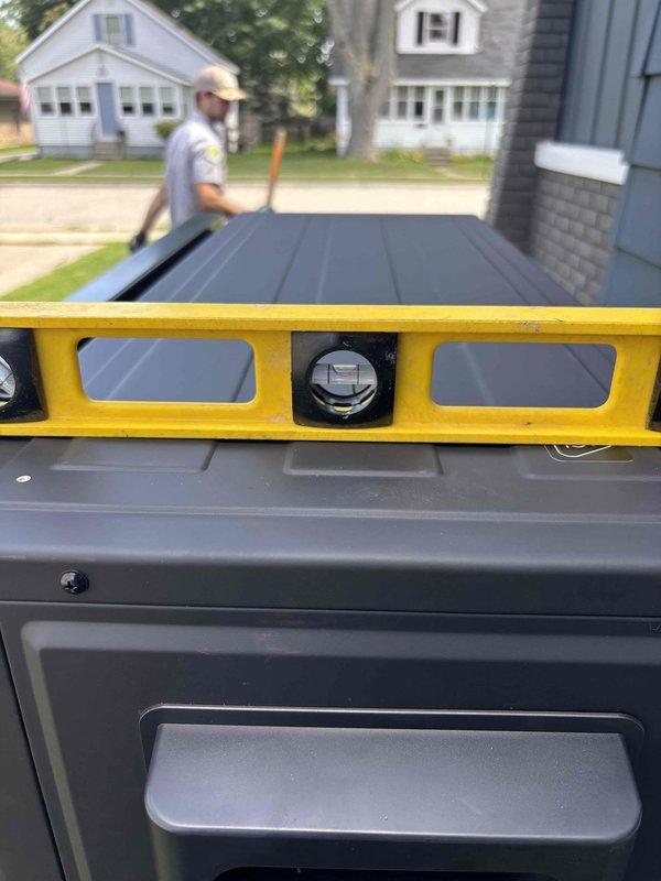 Installed protective plastic pad underneath existing mini split heat pump stand to prevent damage to concrete mounting surface. Verified unit remained level after pad installation and confirmed stable mounting configuration. No-charge service completed as preventative maintenance measure.