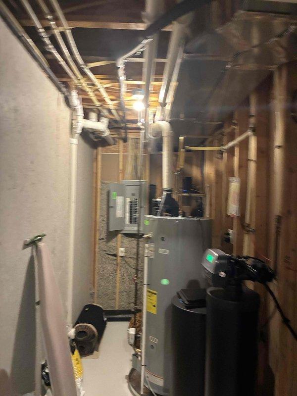 Conducted on-site evaluation for whole house Generac generator installation at a 15-year-old single-family residence with no existing backup power system. Assessed mechanical room containing water heater, HVAC equipment, and associated plumbing infrastructure to determine optimal generator placement and utility connections. Evaluated existing electrical panel configuration, documenting breaker arrangement and available capacity for automatic transfer switch integration. Photographed utility area layout, equipment positioning, and electrical service panel to support equipment sizing recommendations and installation planning.