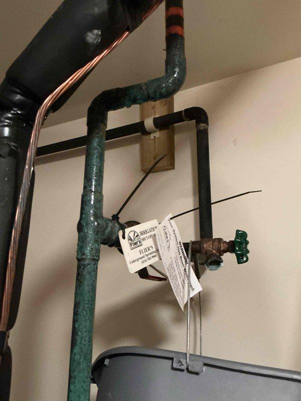 Responded to water heater pan alarm activation. Upon arrival, inspected water heater and surrounding plumbing infrastructure in utility area. Found evidence of water accumulation and floor staining around water heater base, indicating previous or ongoing moisture issues that triggered the alarm sensor. Documented existing conditions including plumbing connections, supply lines, shut-off valves, and water heater installation. Verified alarm functionality and photographed affected areas for service records.
