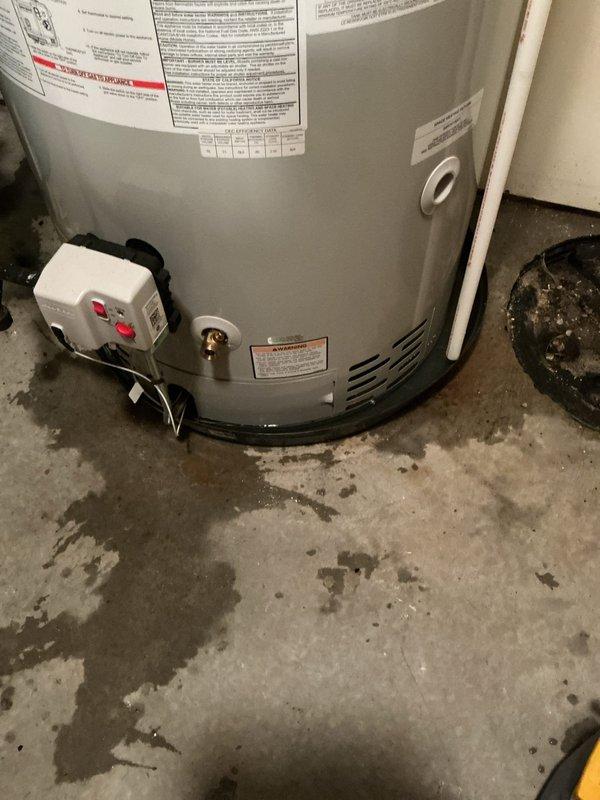 Responded to water heater pan alarm activation. Upon arrival, inspected water heater and surrounding plumbing infrastructure in utility area. Found evidence of water accumulation and floor staining around water heater base, indicating previous or ongoing moisture issues that triggered the alarm sensor. Documented existing conditions including plumbing connections, supply lines, shut-off valves, and water heater installation. Verified alarm functionality and photographed affected areas for service records.