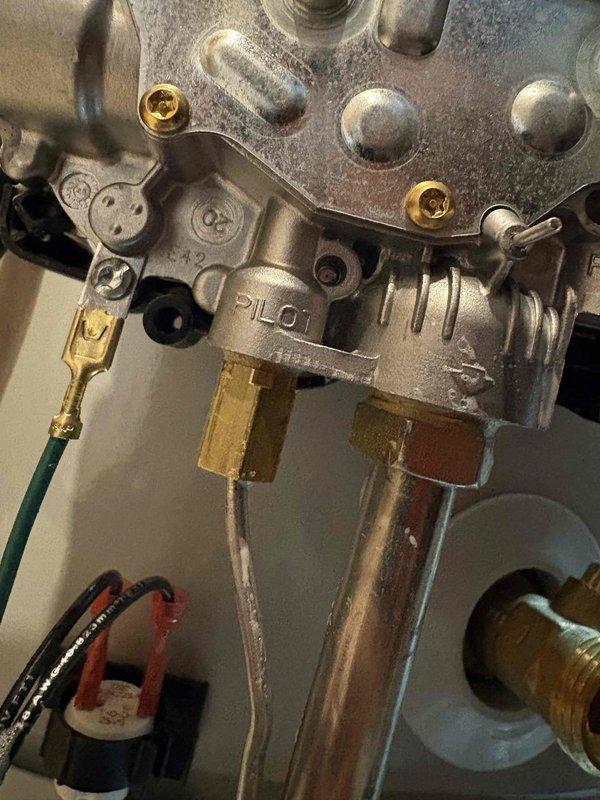 Responded to gas leak call on unit with history of previous gas leak issues from last year when gas control valve was replaced, following complete unit installation in March. Upon inspection, performed thorough leak check of gas valve assembly, manifold connections, and all brass fittings. Verified all connections at gas control valve were secure and properly tightened. No active gas leak detected during testing. Unit operating normally with no safety concerns identified. Documented equipment condition with photos showing gas valve assembly, brass port connections, and mounting hardware. Classified as technician discretion/no charge service call.