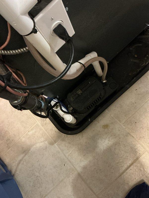 Completed annual cooling system maintenance on residential HVAC unit. Performed comprehensive inspection of furnace and air conditioning components, including refrigerant lines, condensate drainage system, and electrical connections. Documented equipment condition with photos showing proper operation of copper tubing, PVC piping, and drain pan assembly with normal operational wear present.