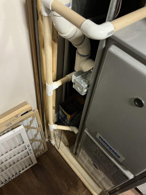 Provided estimate for new furnace installation at side-by-side residence with existing 20-year-old unit. Inspected current HVAC system including furnace, ductwork, humidifier, PVC condensate drainage system, and air handler components in utility space. Documented existing equipment configuration and installation area for replacement planning.