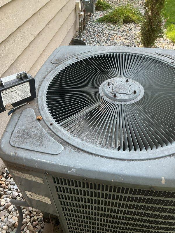 Completed annual cooling maintenance on 14-year-old Goodman system with 2017 condenser model as part of maintenance subscription. Performed comprehensive tune-up inspection of outdoor condenser unit, verified proper operation of fan assembly and electrical components, and documented equipment condition through photographic records. Unit found operating within normal parameters with typical weathering for age and exterior installation.