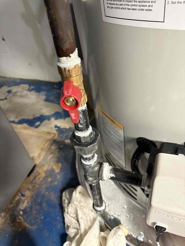 Corrected disapproved gas piping installation on water heater to meet code requirements. Installed proper gas shut-off valve with red handle at water heater connection and rectified improperly installed drip leg on gas line per inspection requirements. Verified all gas connections are secure with appropriate Teflon tape application on threaded fittings, ensuring safe and compliant operation. Reinspection has been scheduled to obtain final approval.