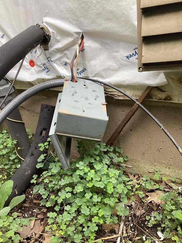 Completed annual cooling maintenance on 20-year-old Carrier air conditioning system. Performed comprehensive tune-up inspection of outdoor condensing unit, electrical disconnect box, and refrigerant line connections. Documented equipment condition with photographs showing weathered disconnect box, refrigerant lines, and electrical wiring in serviceable condition despite age and outdoor exposure. Noted vegetation overgrowth around equipment base requiring customer attention to maintain proper clearance and airflow. All system components operational at time of inspection.