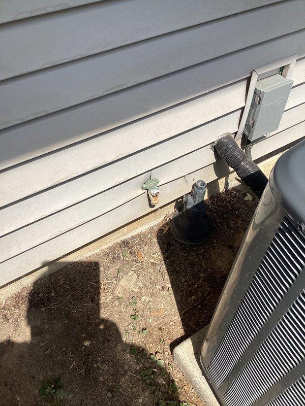 Responded to service call for low water pressure at outdoor spigot. Upon inspection, identified moisture intrusion issues in basement utility area with visible mold growth on concrete surfaces near plumbing connections. Examined exterior hose bib and associated supply lines, checking for obstructions, valve functionality, and potential leaks affecting water flow. Assessed HVAC condensate drain routing near exterior spigot location to rule out cross-connection or drainage interference. Documented existing conditions with photographs showing interior water damage and exterior plumbing configuration for customer records and potential follow-up remediation work.