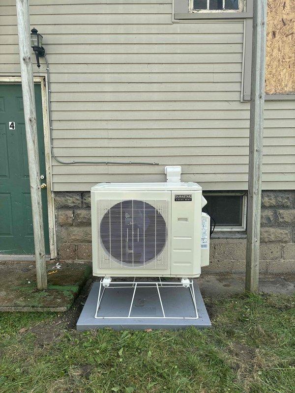 Completed full installation of multi-zone ductless mini-split system including three outdoor condenser units mounted on brackets and protective platforms at ground level. Installed refrigerant line sets, electrical conduit, and condensate drain piping connecting outdoor units to indoor air handlers, with all penetrations properly sealed and line sets secured to building exterior. System tested and verified operational with all zones functioning properly.